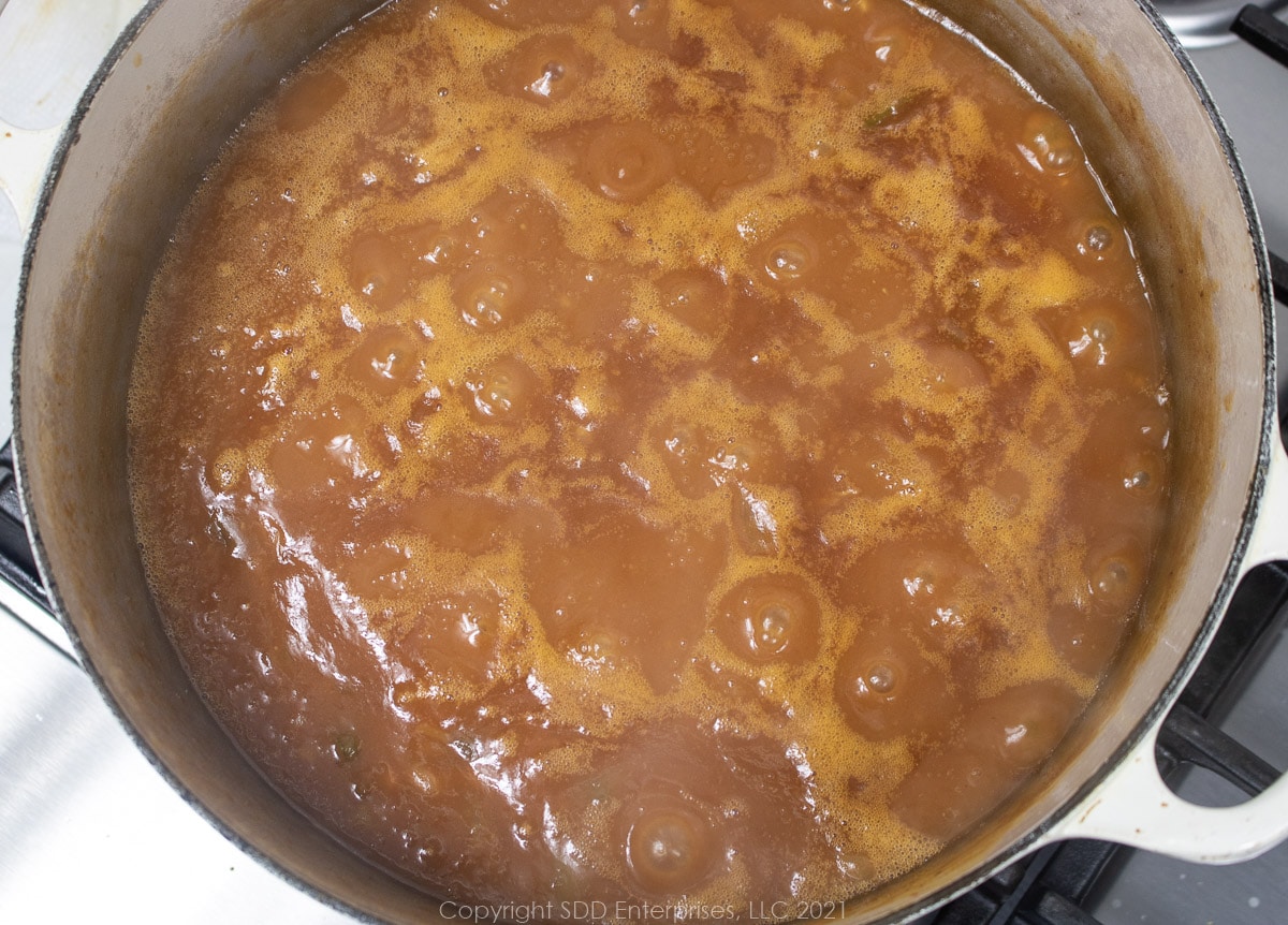 canned beans simmering in a Dutch oven