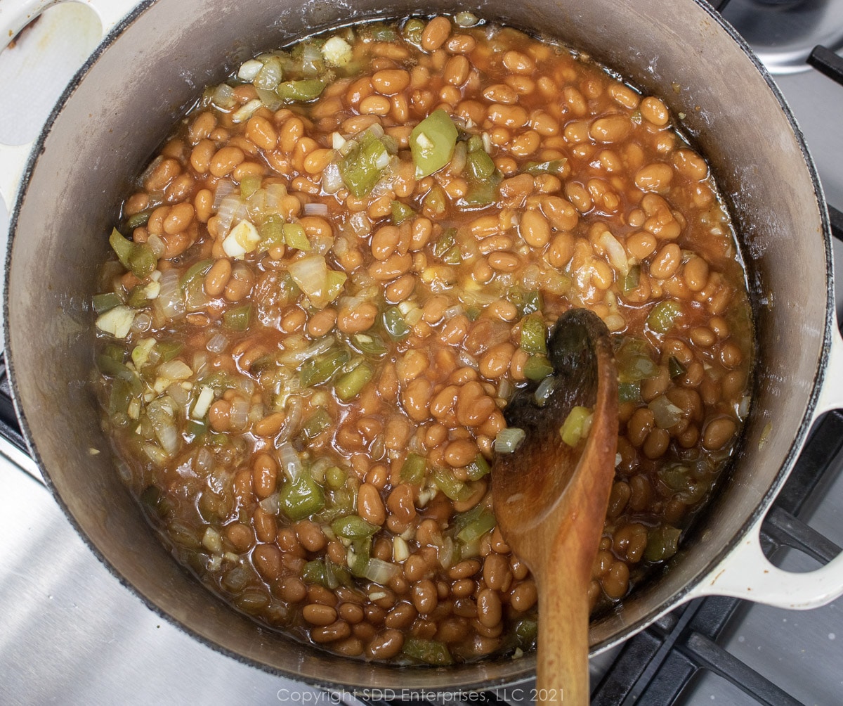 canned beans added to sauteed vegetables in a Dutch oven