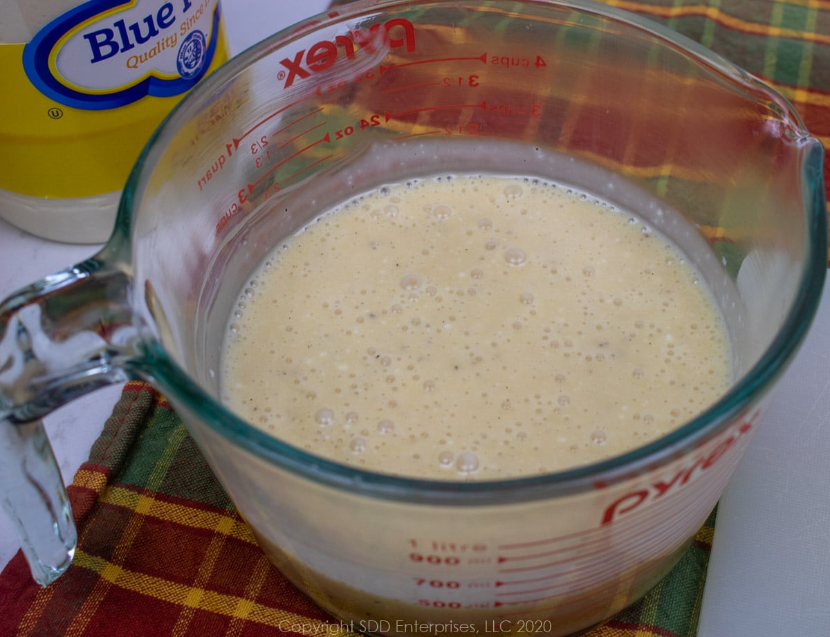 coleslaw dressing in a measuring cup