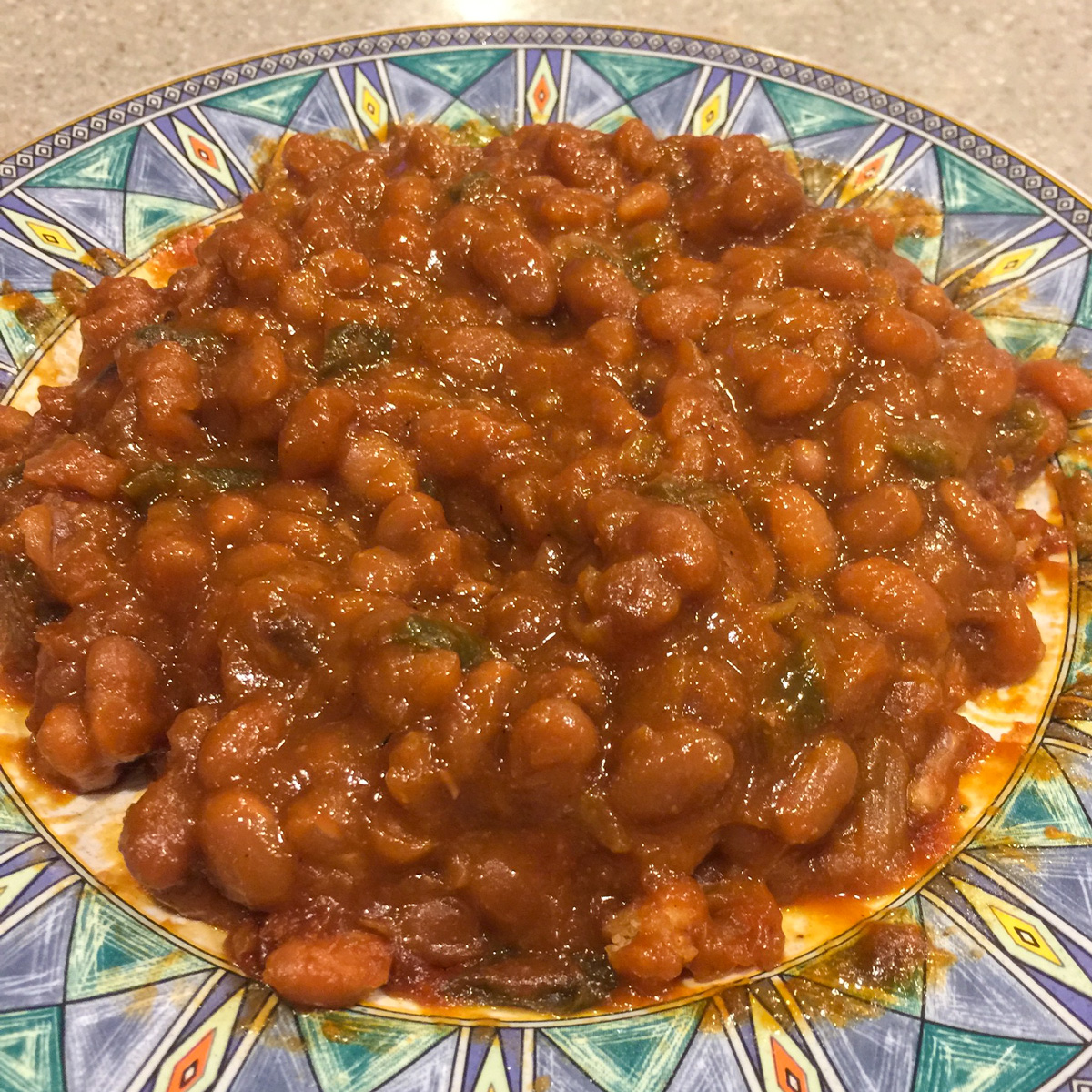 baked beans on a green and blue plate