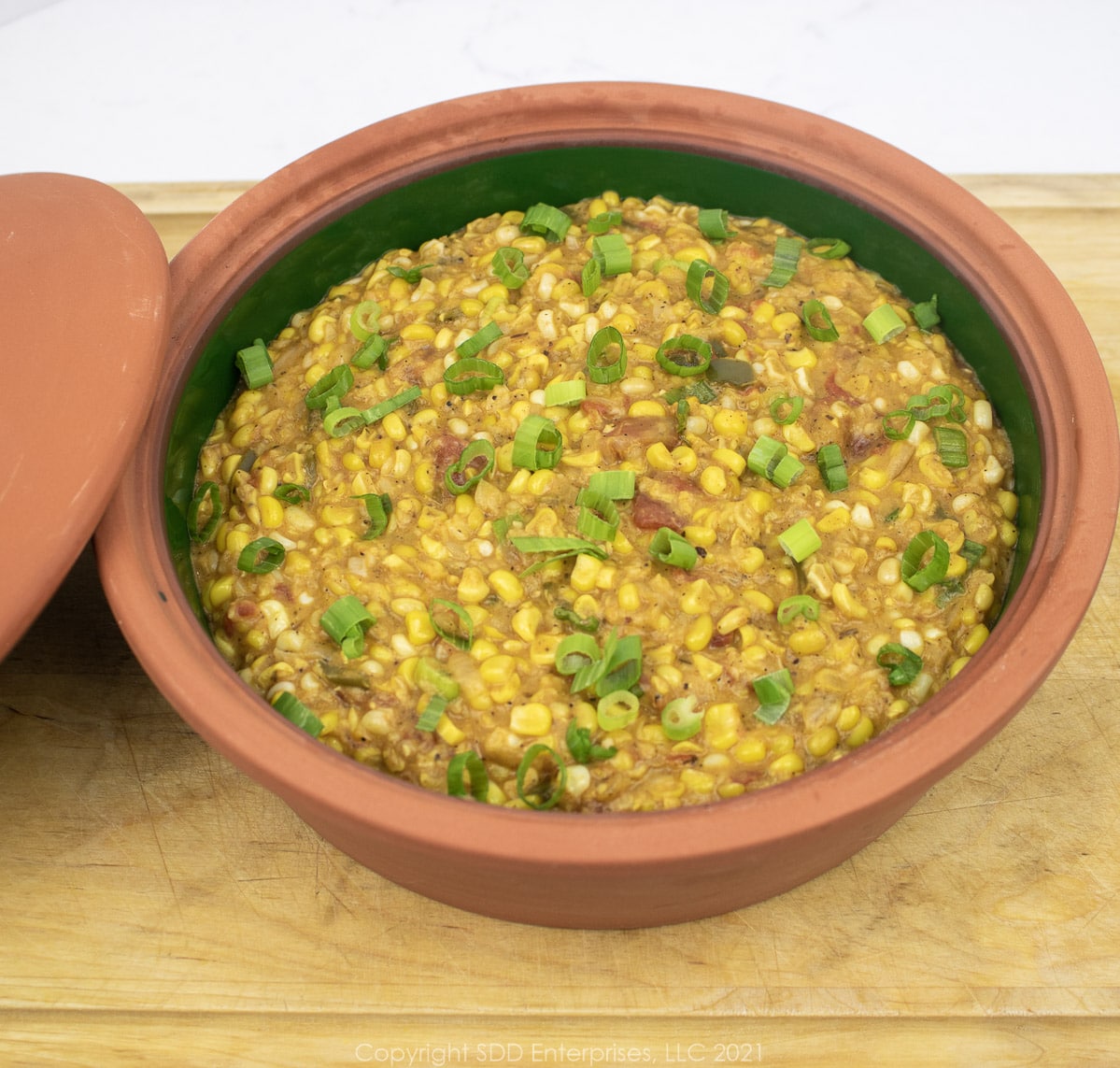 corn maque choux in a brown bowl