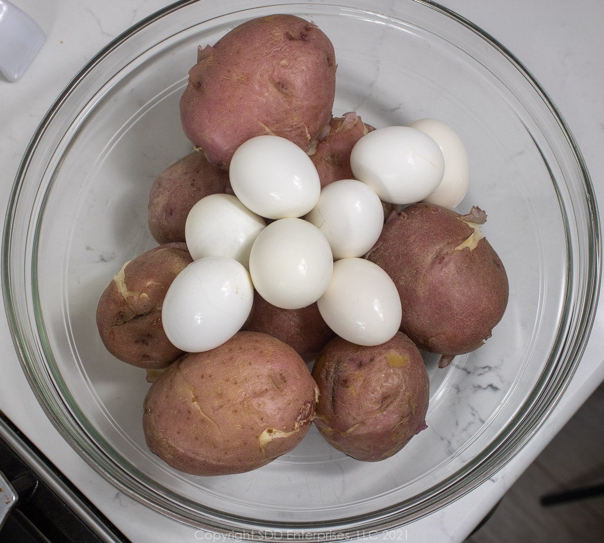 boiled eggs and potatoes in a glass bowl