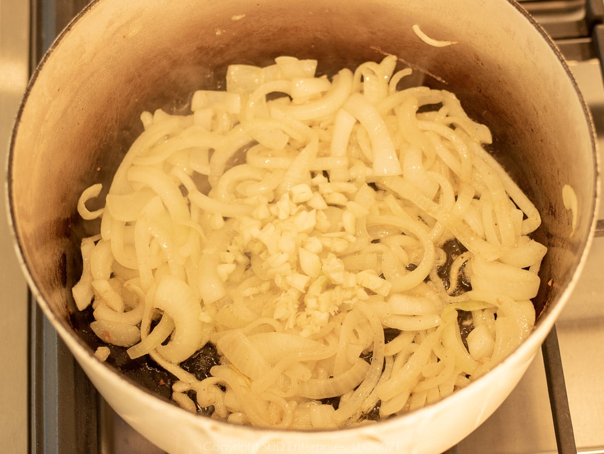 garlic and onions sautéing in a Dutch oven