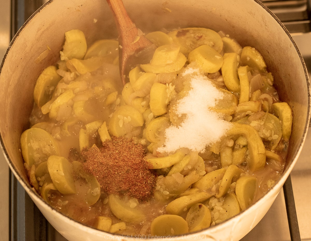 seasonings added to squash in a Dutch oven