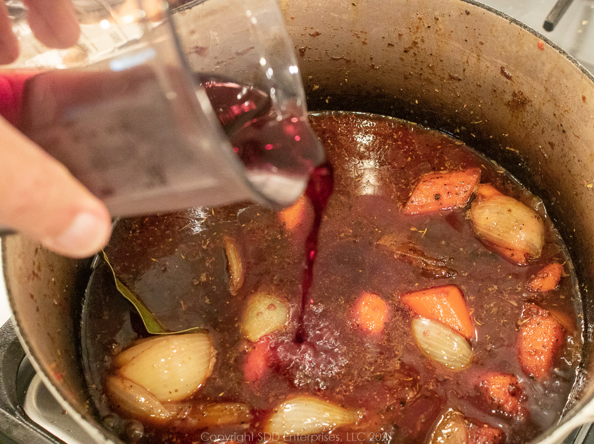 wine and stock added to Dutch oven with vegetables