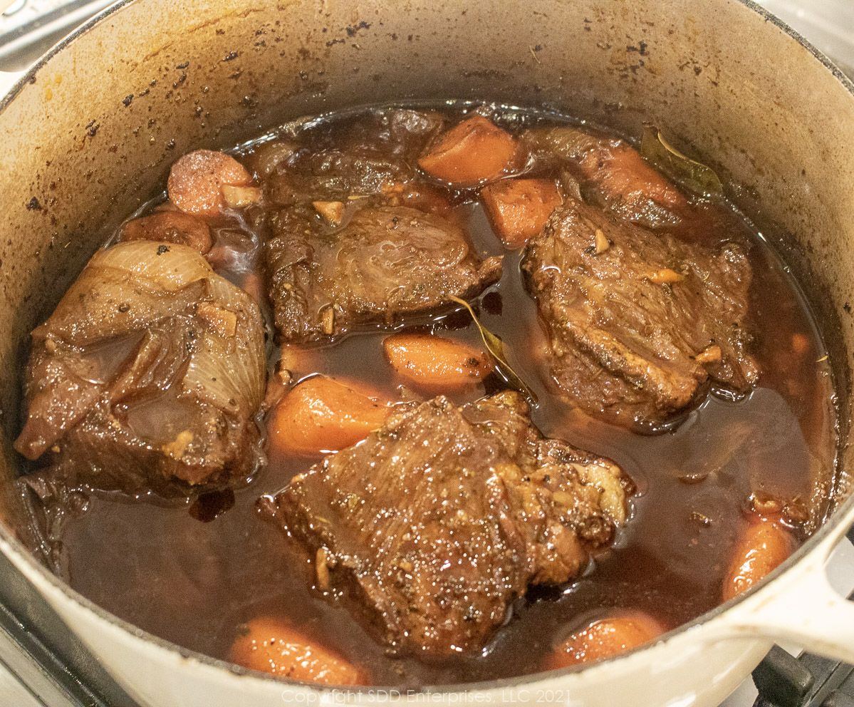 beef short ribs braising in in wine and stock 