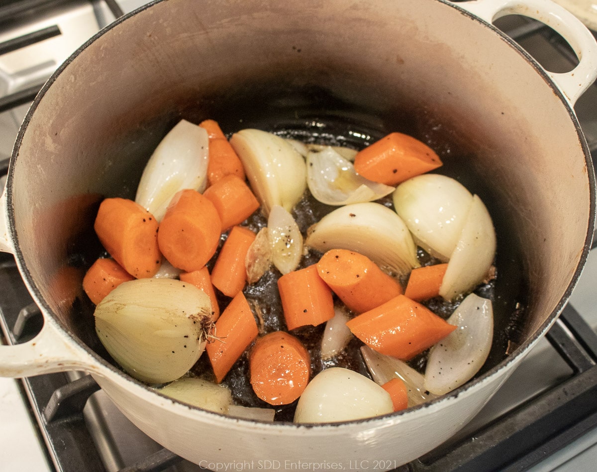 carrots and onions in a Dutch oven