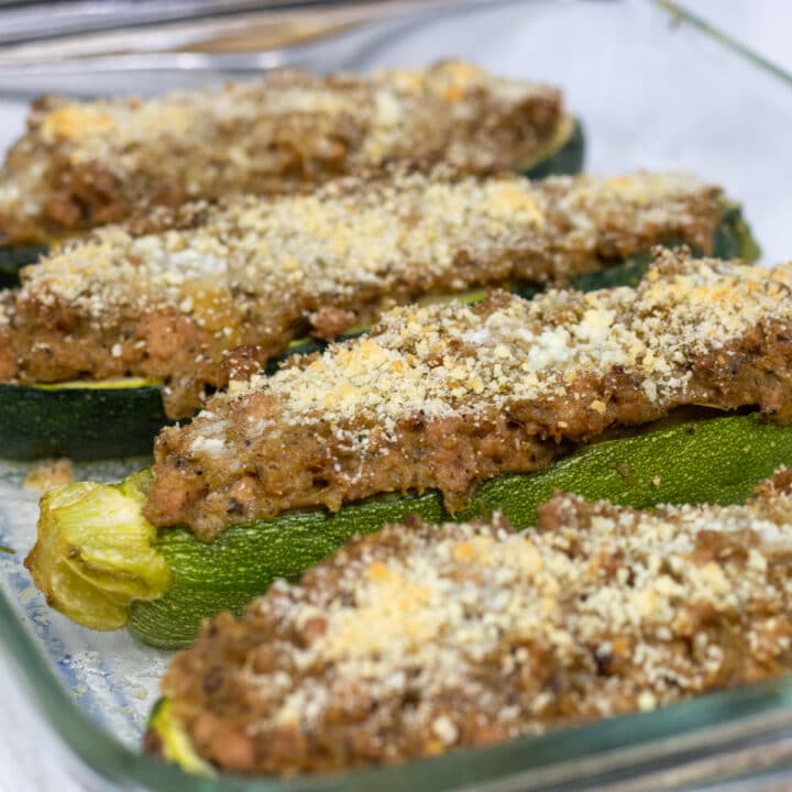 zucchini stuffed with pork on a baking dish