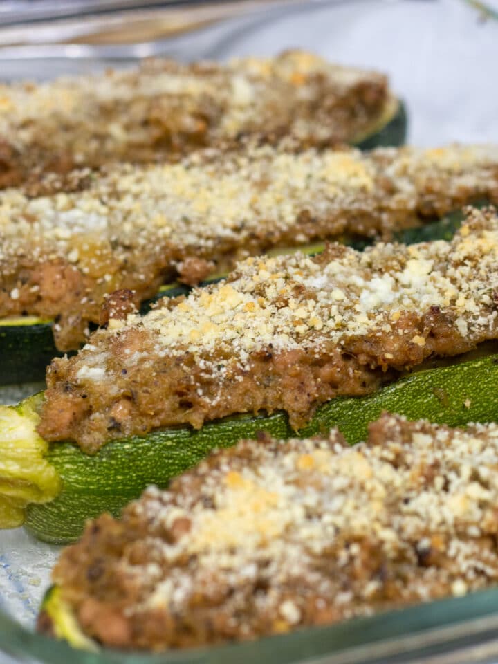 zucchini stuffed with pork on a baking dish