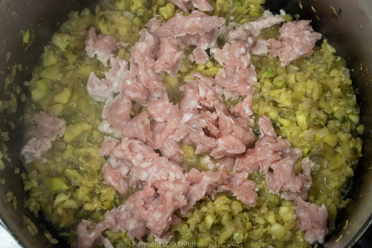 ground pork with chopped vegetables in a Dutch oven