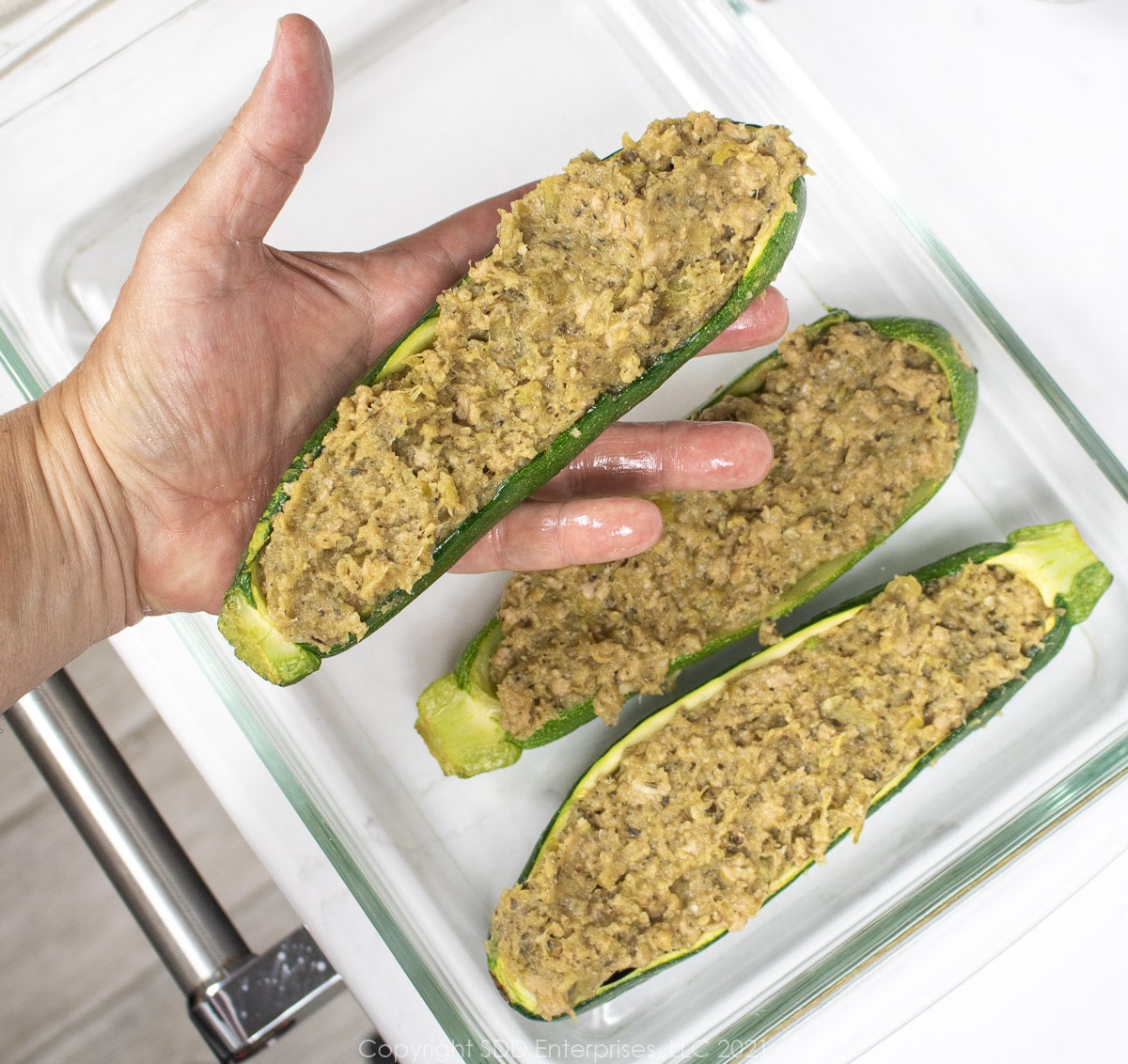 filling stuffed into hollowed zucchini and placed in a baking dish