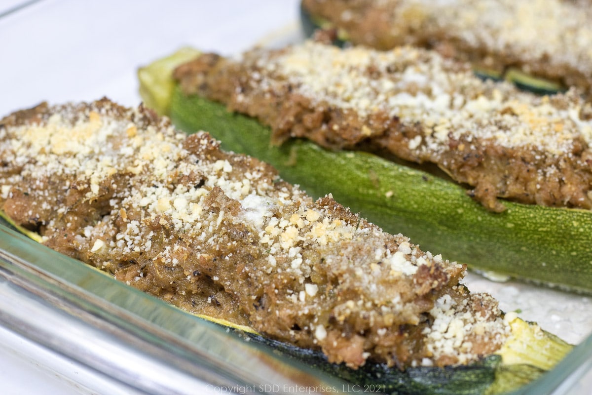 zucchini stuffed with pork on a baking dish