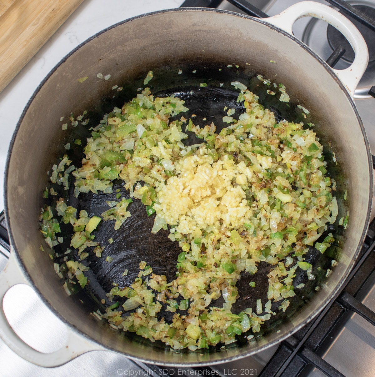 garlic and the trinity frying in a Dutch oven