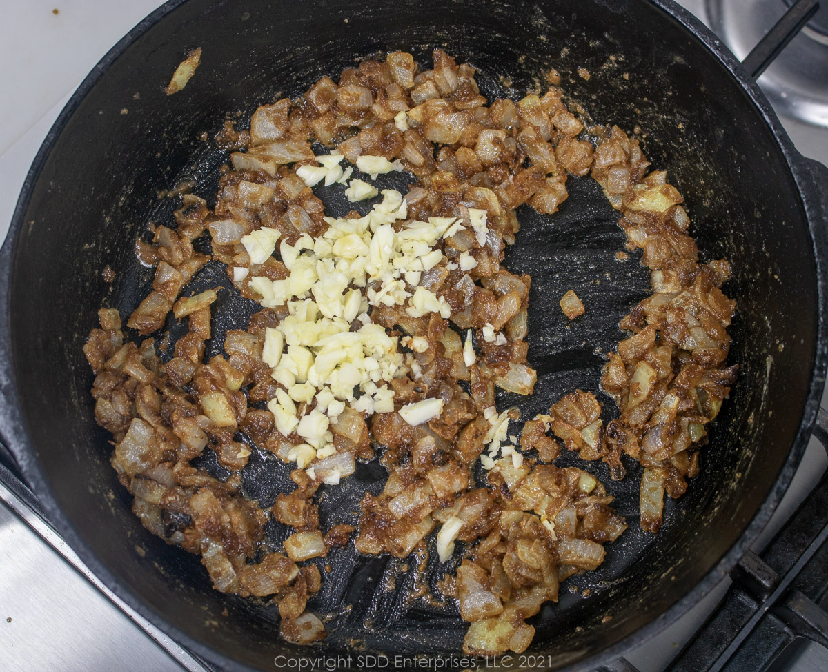 Garlic and onions in a roux in a Dutch oven