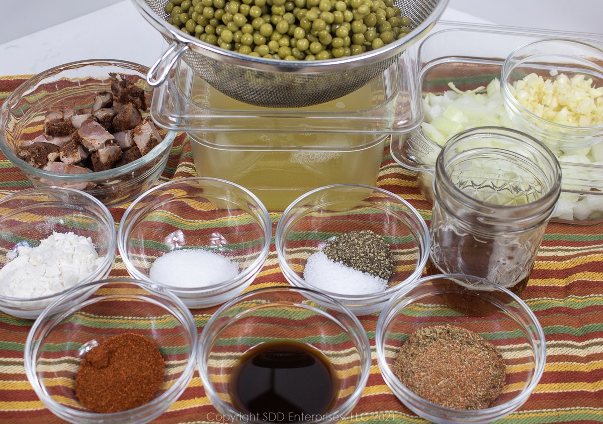 prepared ingredienst for peas in a roux laid out in prep bowls