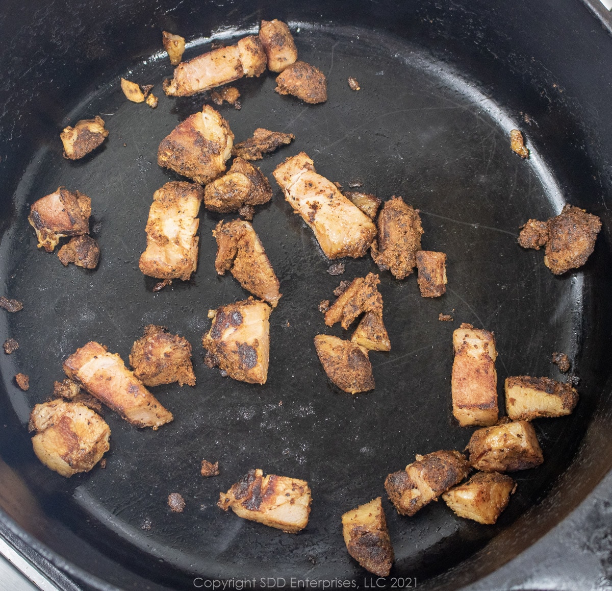 tasso (seasoned ham) frying in a Dutch oven