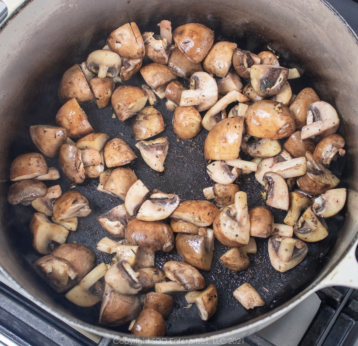 mushrooms browning in a Dutch oven