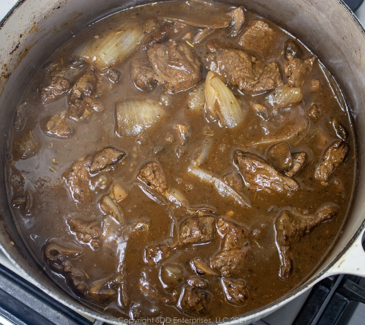 simmering beef stew in a Dutch oven