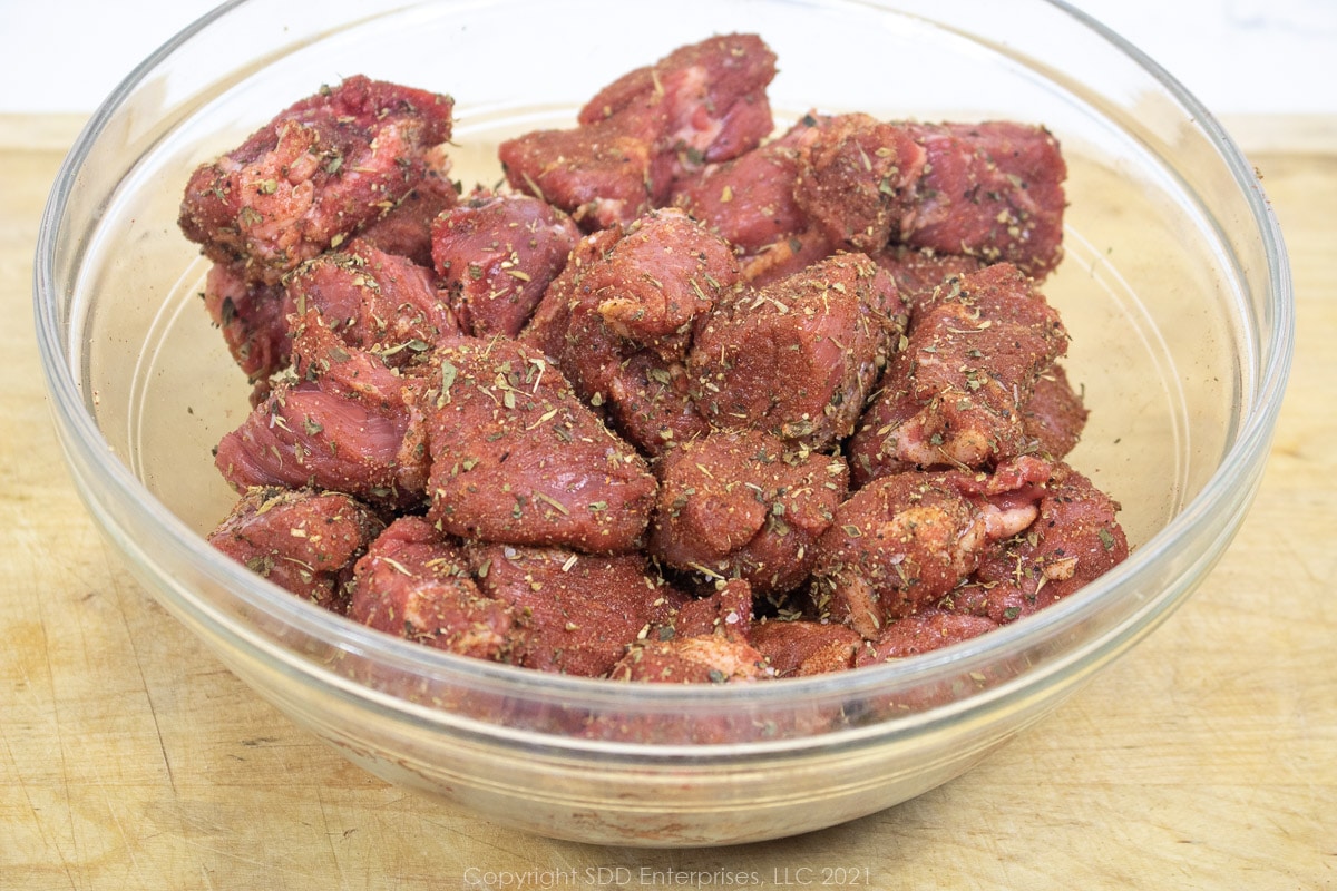 cubed chuck roast with creole seasoning in a bowl