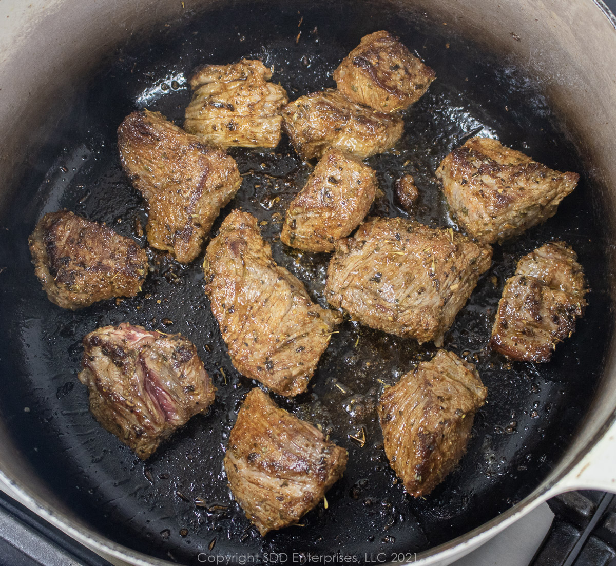 beef chunks browning in a dutch oven