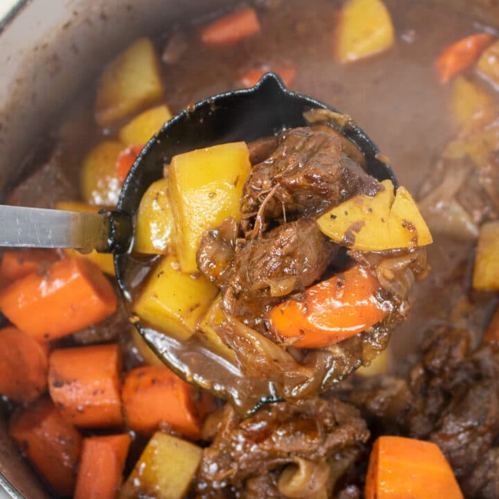 beef stew with potatoes and carrots in a ladle
