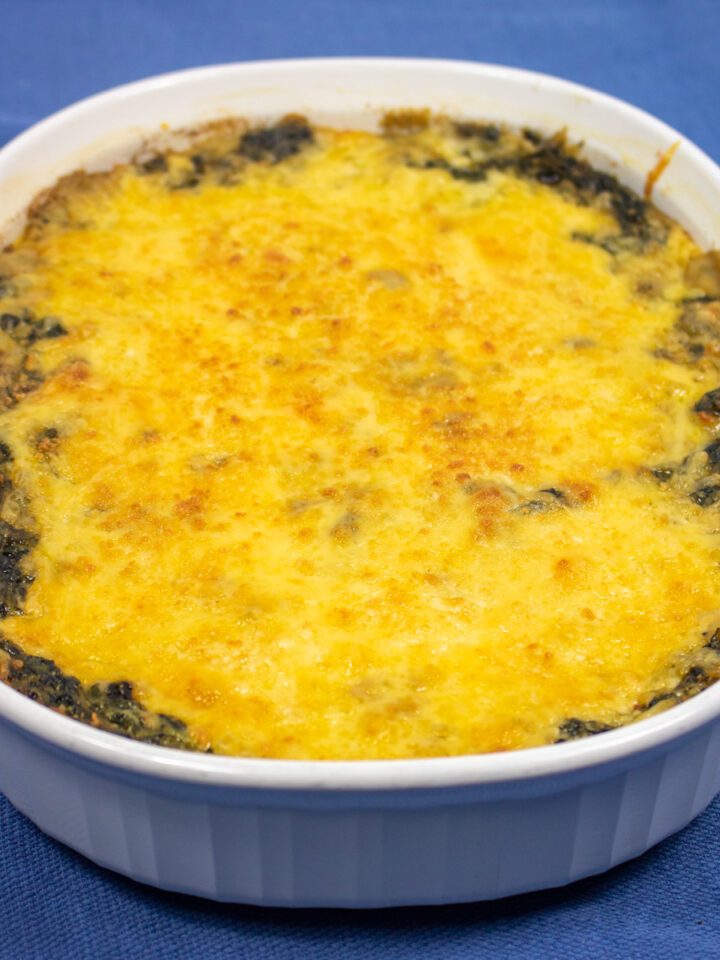 creamed spinach with mushrooms in a white baking dish