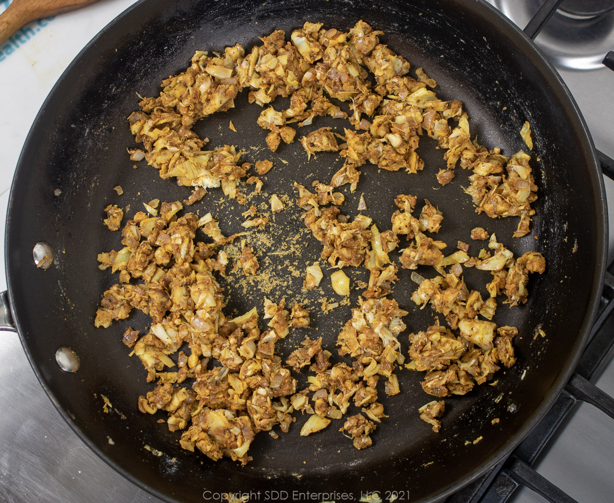 artichoke hearts and seasonings in a sauté pan