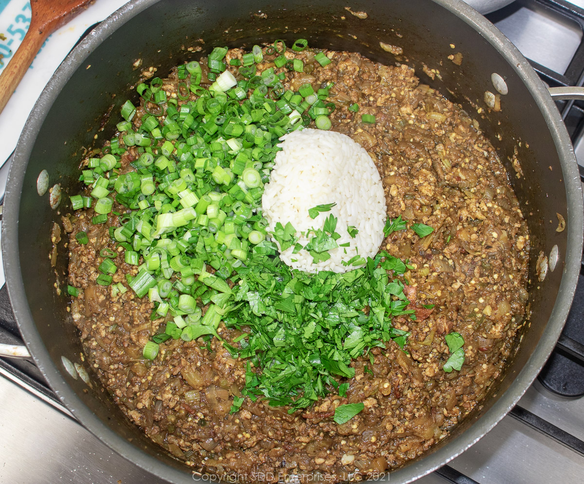 cooked rice, green onions and parsley added to dressing mixture