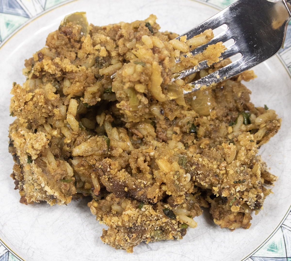Cajun Eggplant Dressing on a fork over a plate