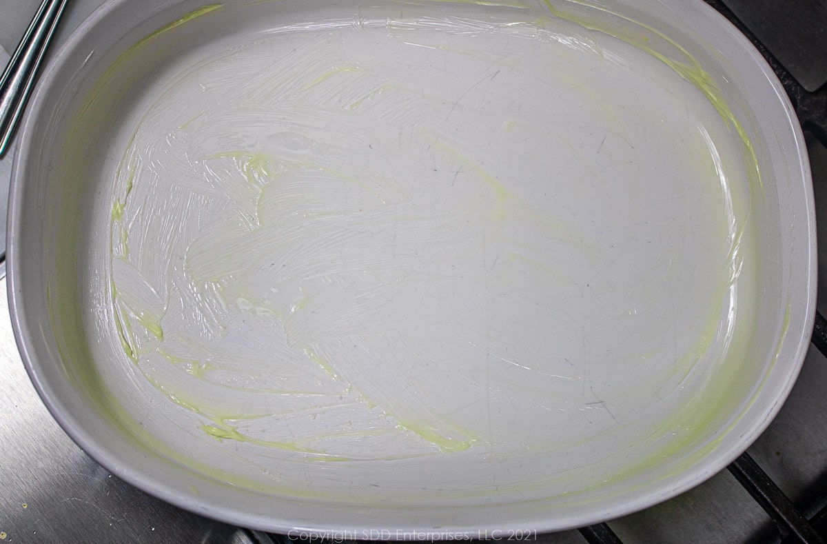 baking dish with softened butter to prepare for the oven