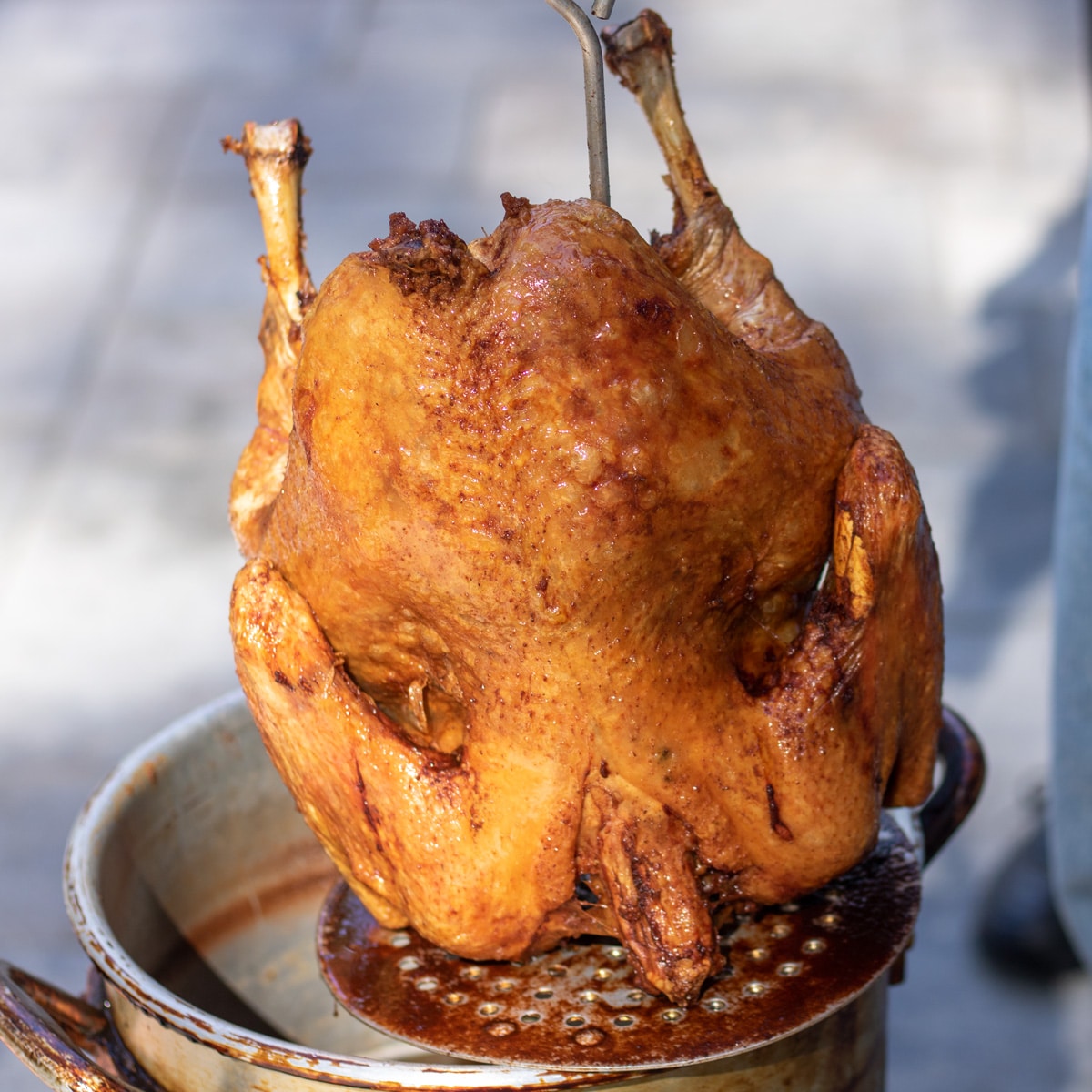 a turkey being lifted out of a fryer