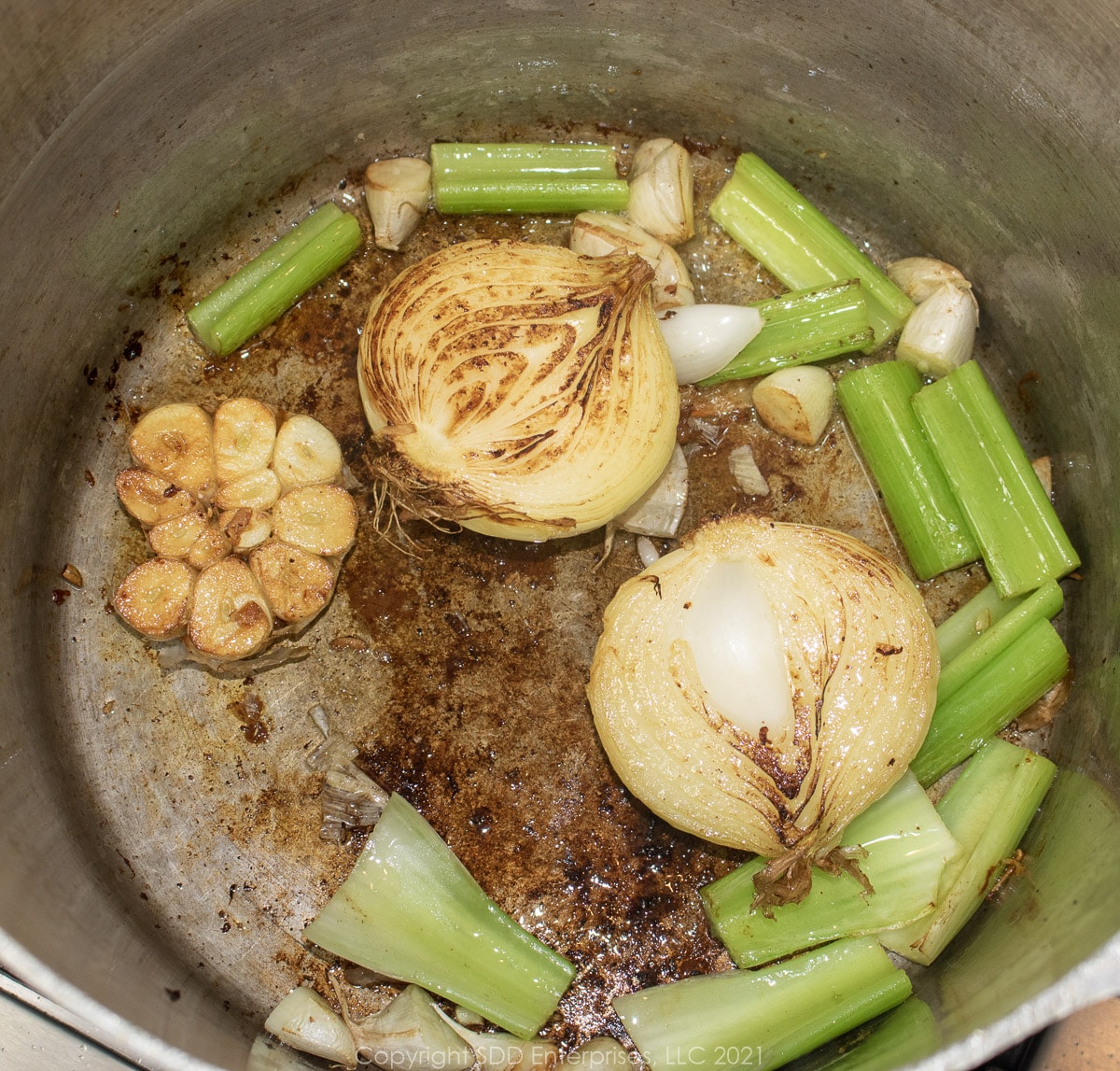 browning vegetables in chicken fat in a stock pot