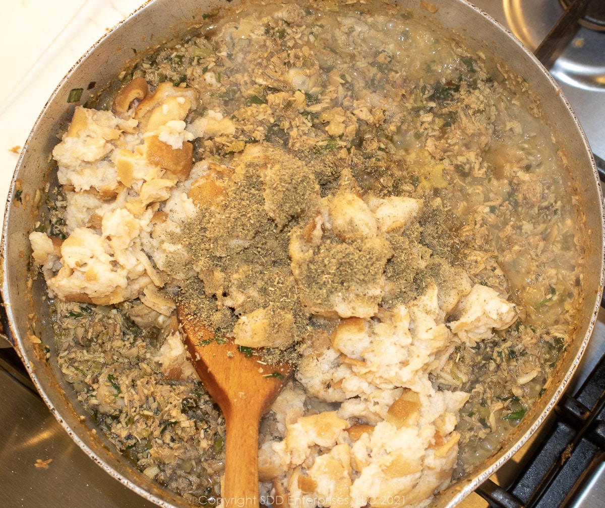 soaked stale bread and sage added to dressing mixture in a stock pot