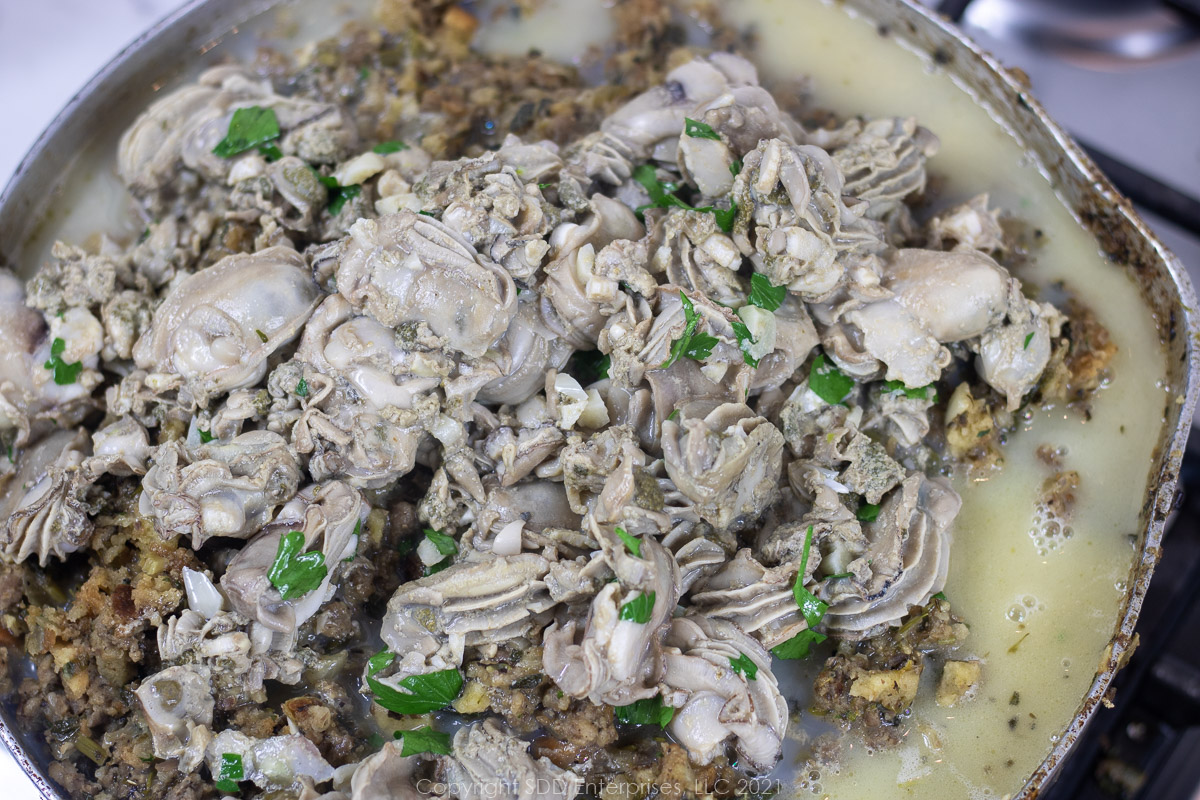 scalded oysters and parsley added to dressing mix in a frying pan