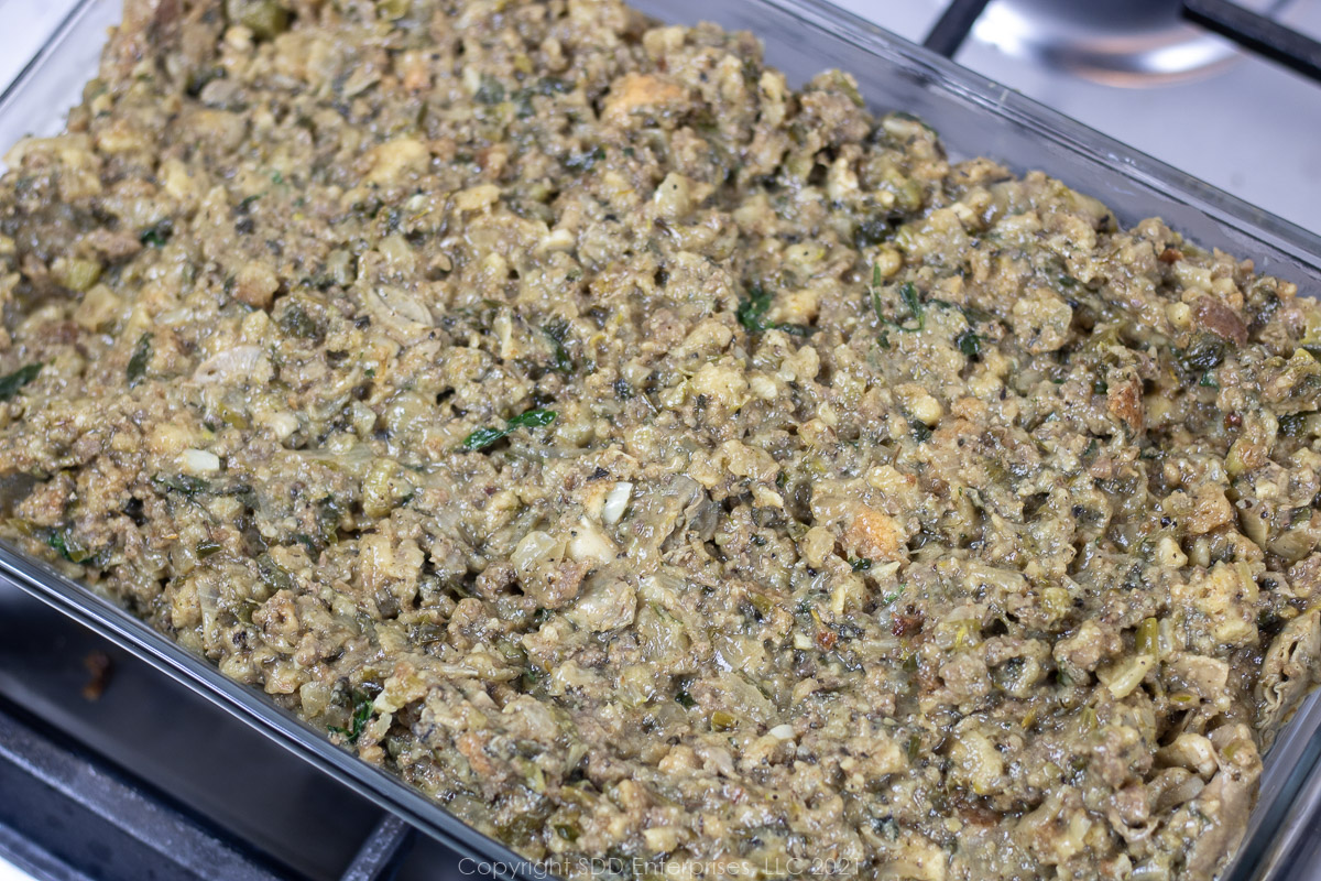 oyster dressing in a glass baking dish ready for the oven