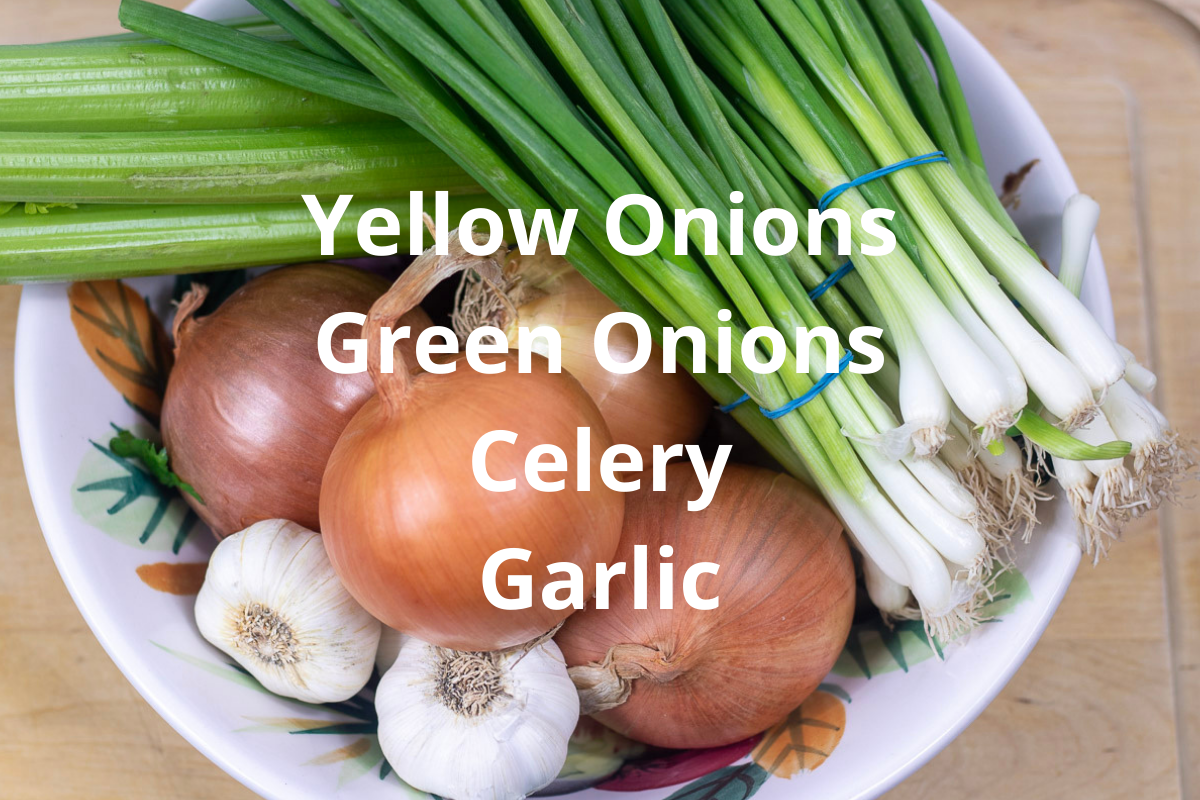 onions, garlic and celery in a colorful bowl