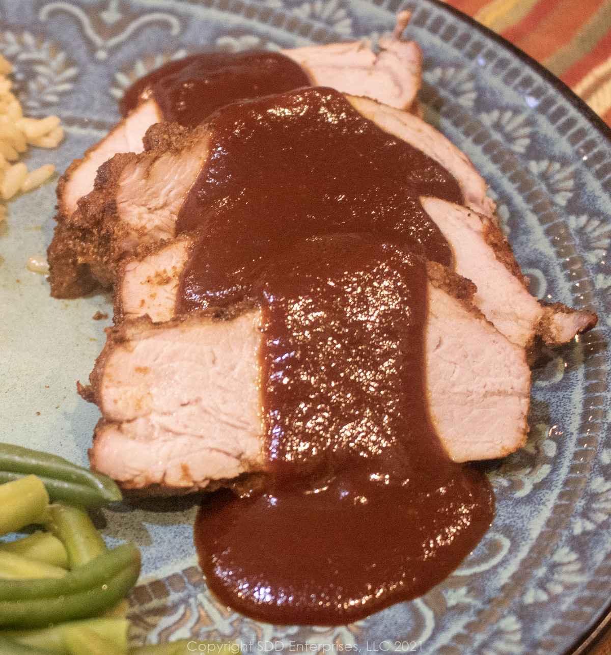 cranberry bq sauce poured over pork tenderloin