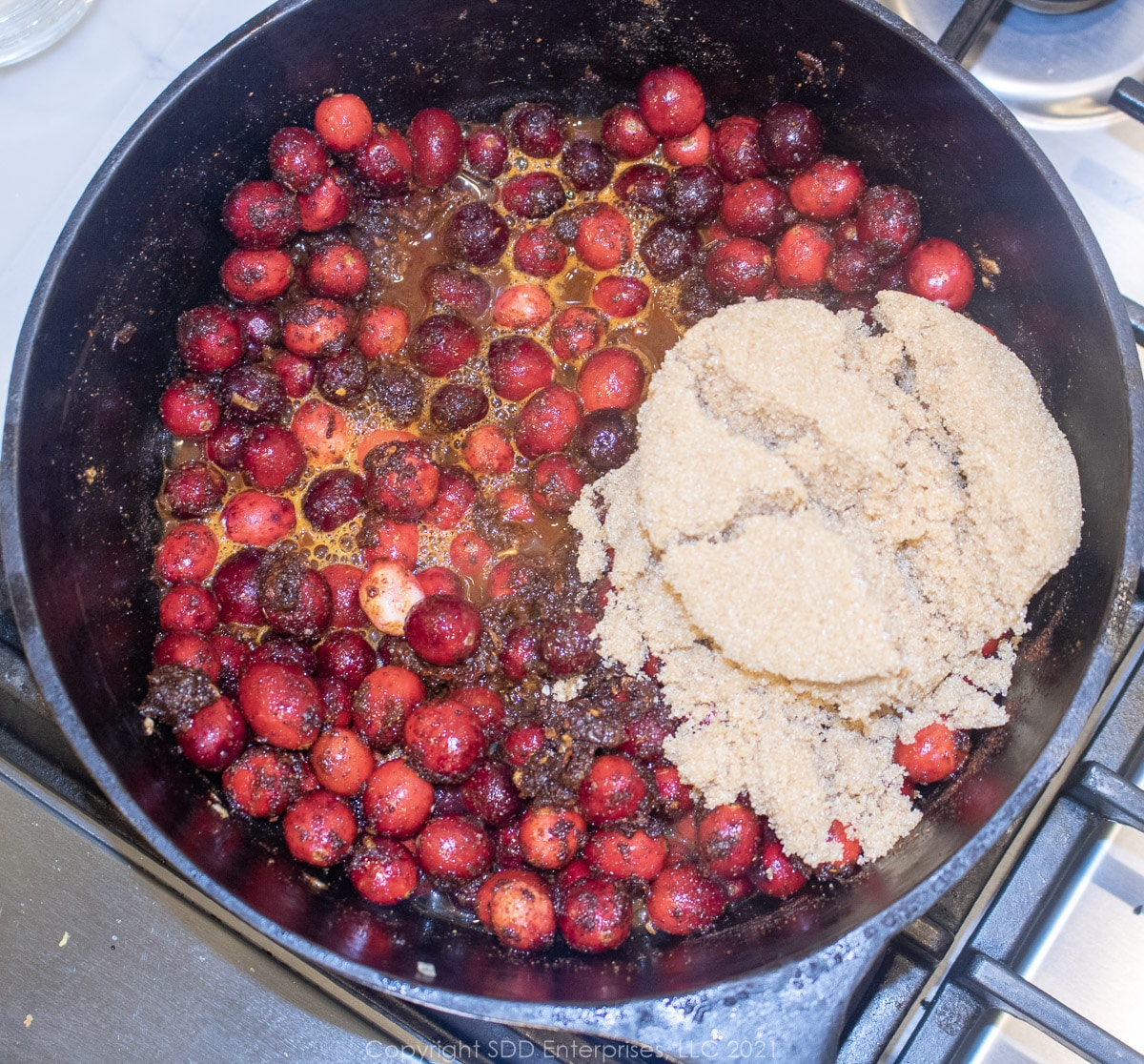 brown sugar, lemon juice, and apple cider vinegar added to a Dutch oven with onions, peppers and spices for homemade bbq sauce