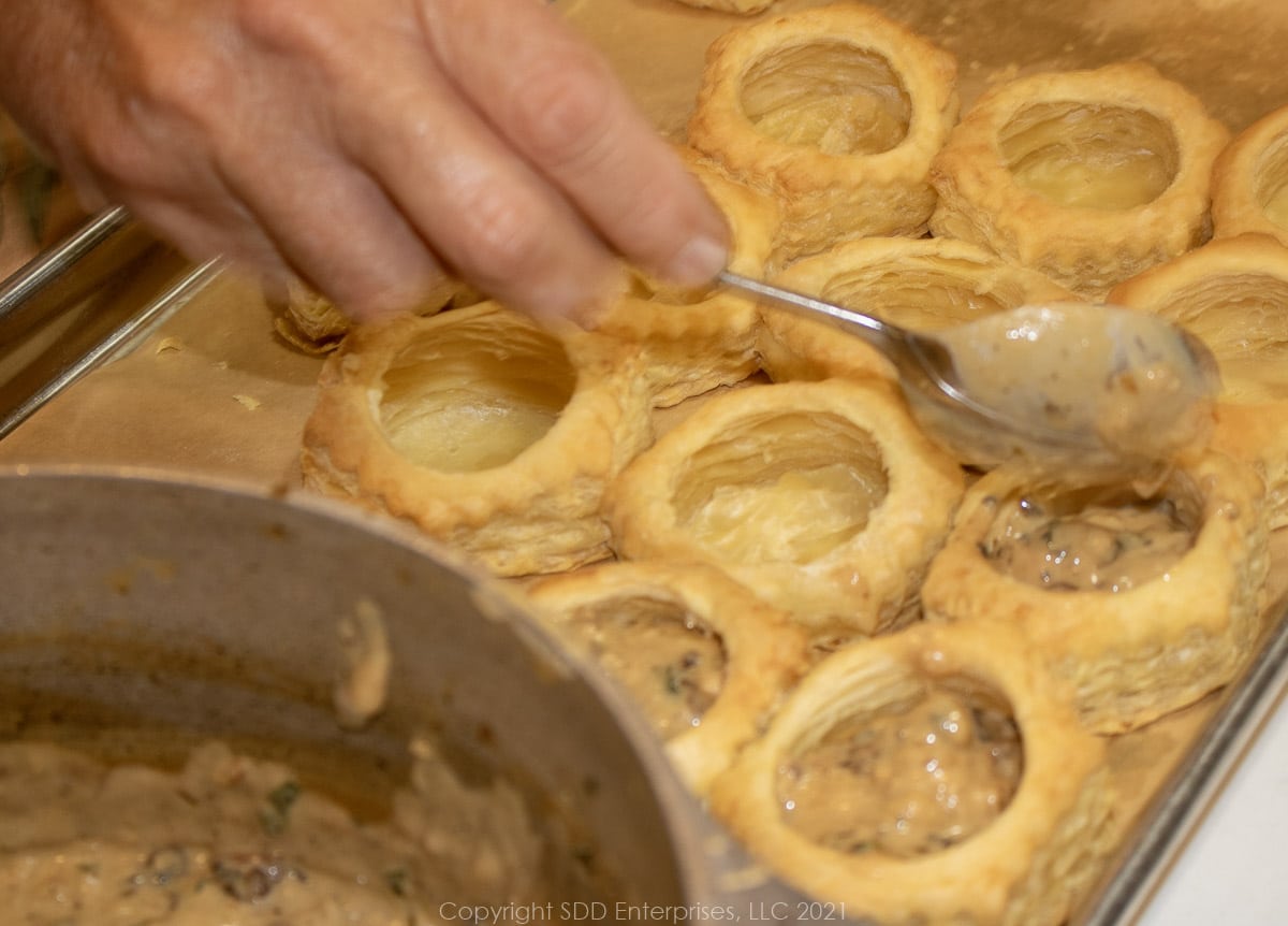 filling pastry shells with oyster filling