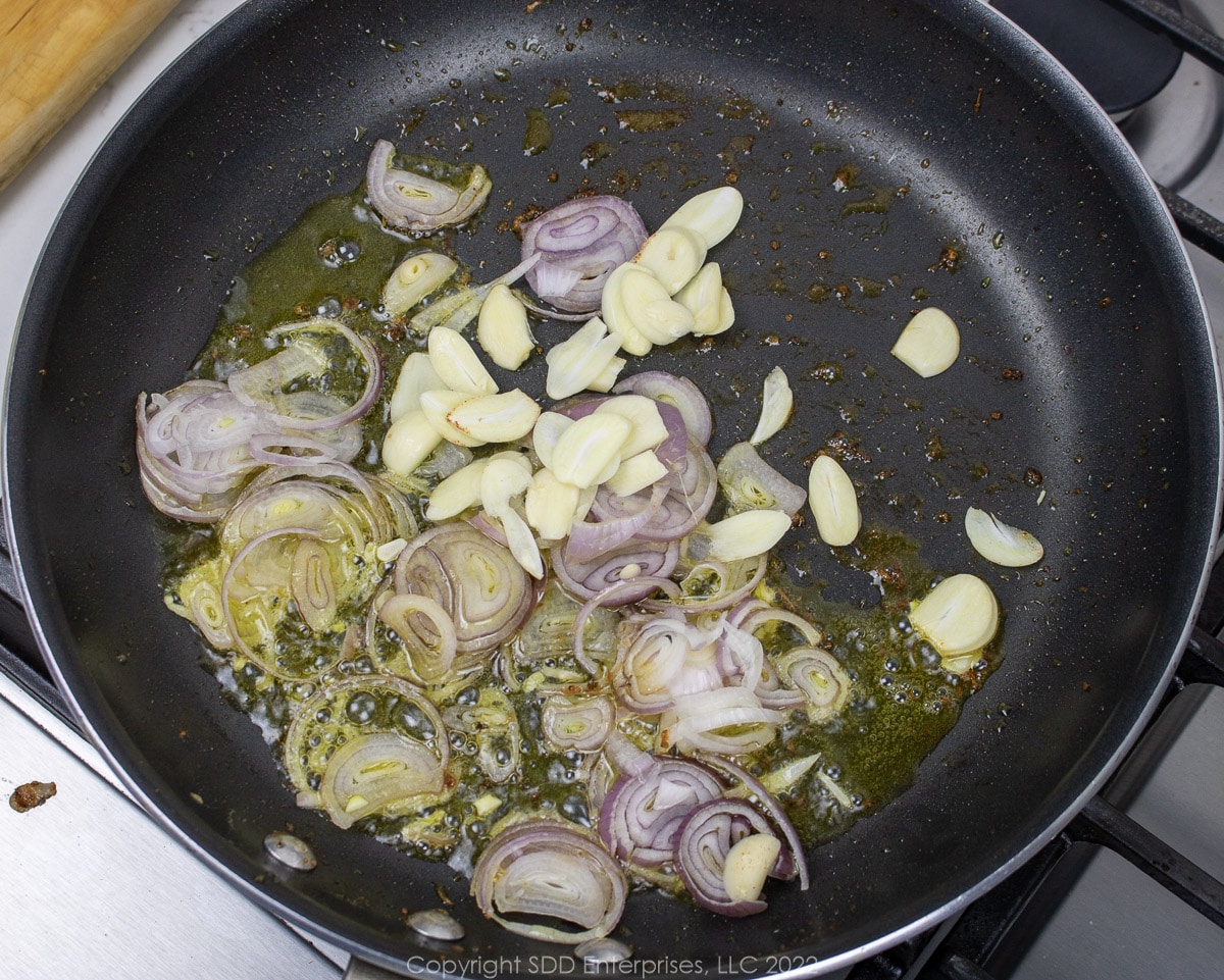 shallots and garlic sautéing in a pan