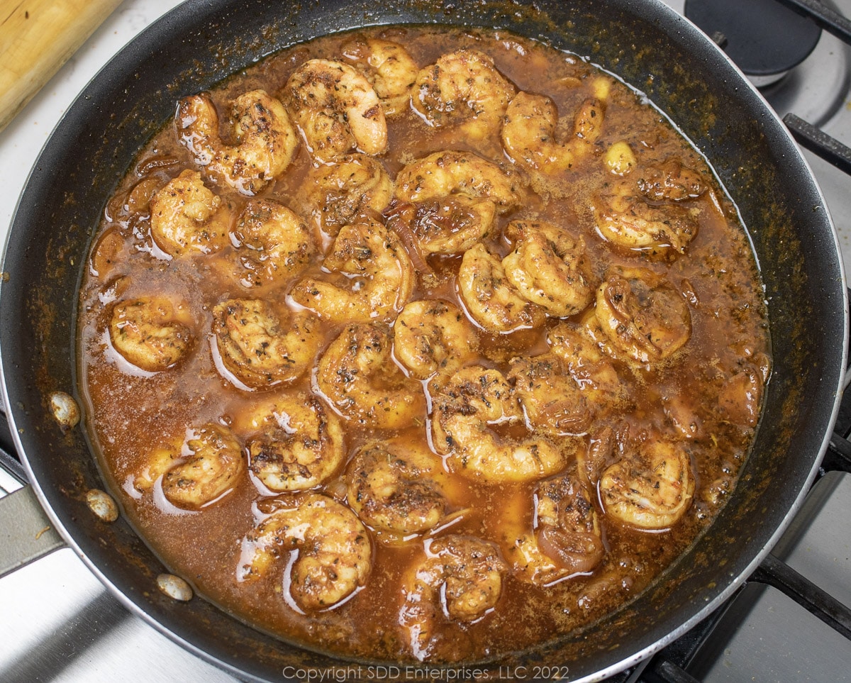 shrimp added to sauce in a sauté pan