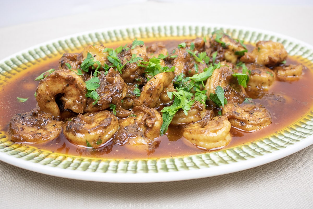 creole shrimp scampi on a green and white platter