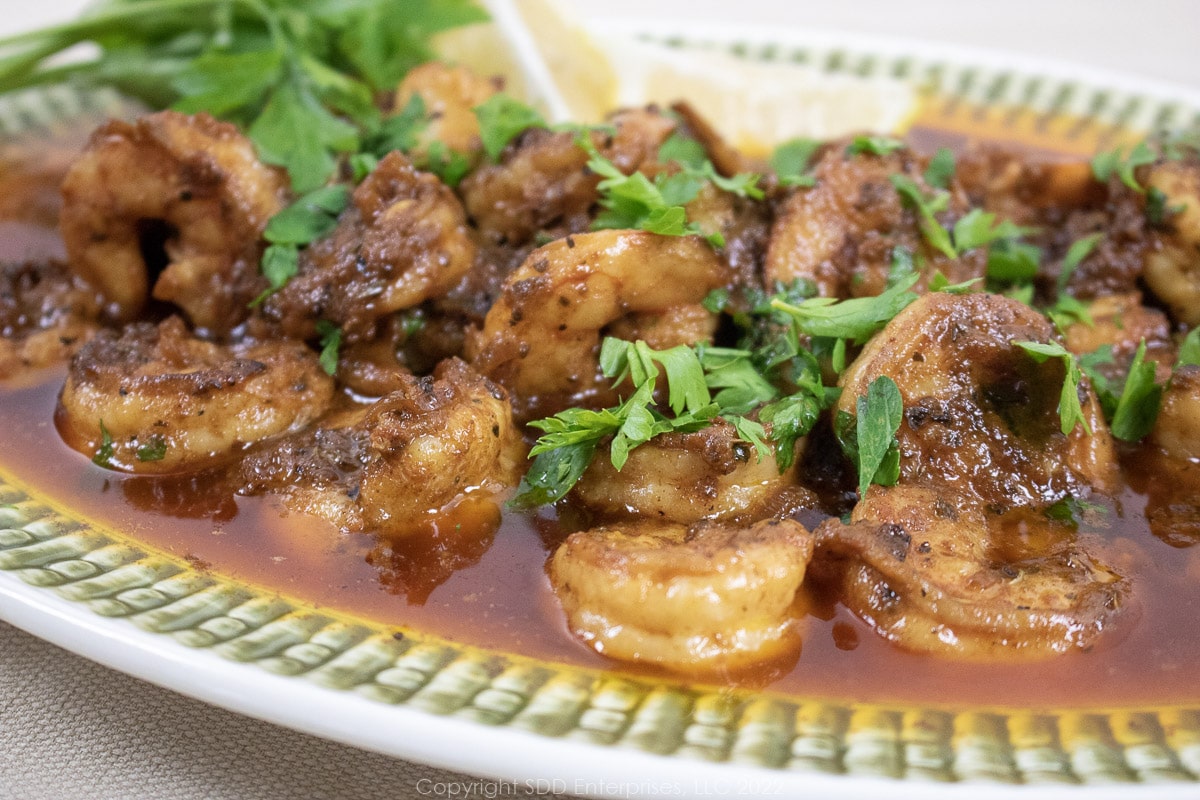 creole shrimp scampi on a green and white platter