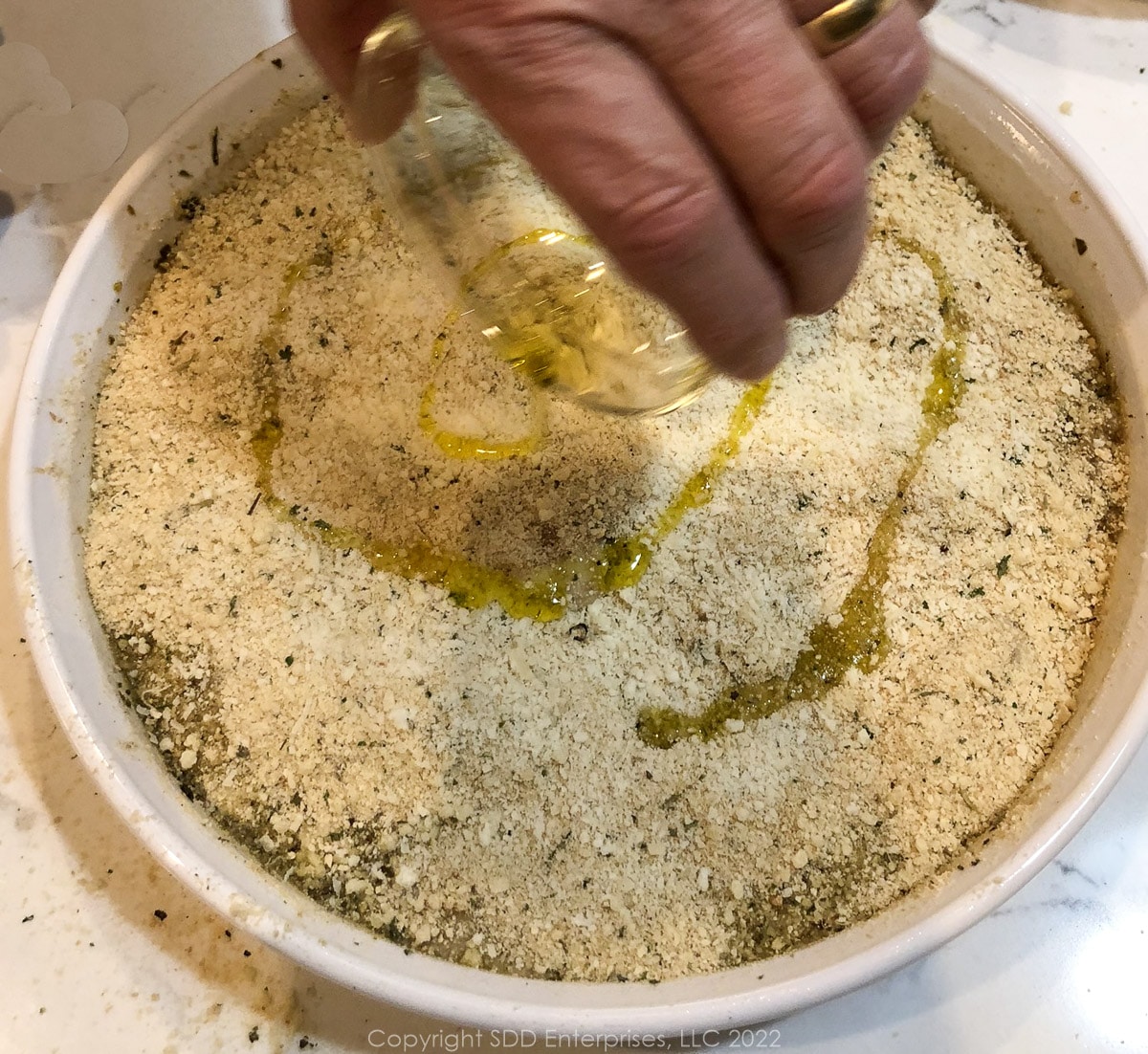 oysters topped with breadcrumbs and olive oil in a baking dish