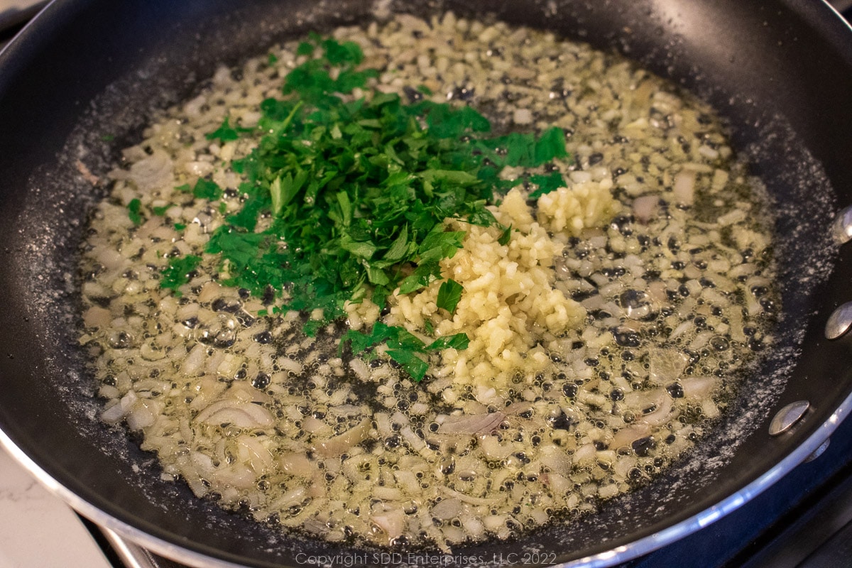 chopped garlic and parsley sautéing with shallots in butter