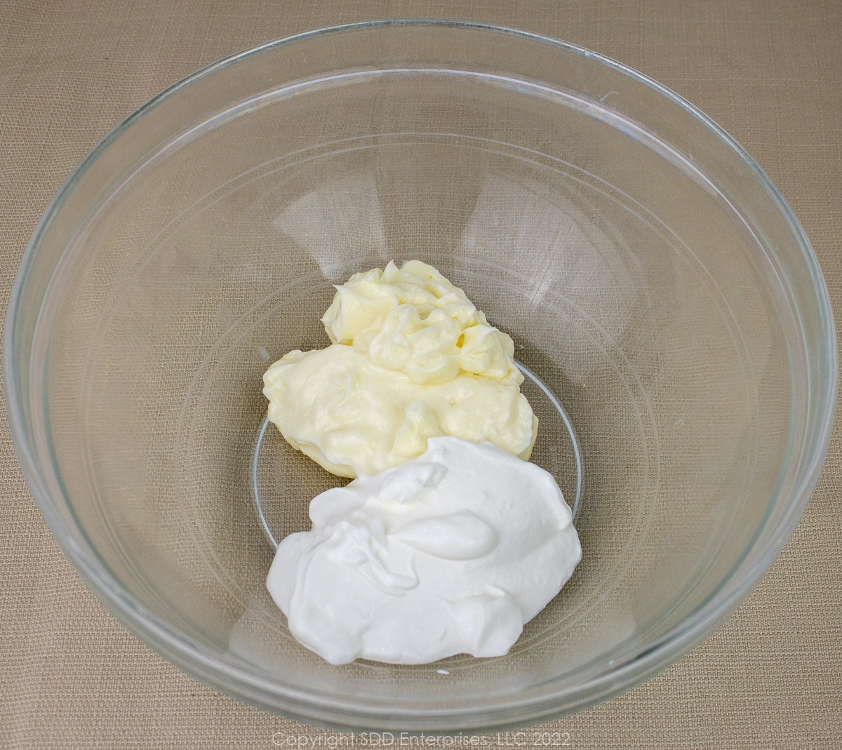 mayonnaise and sour cream in a glass bowl