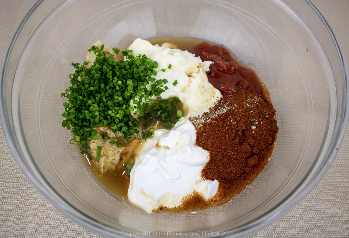 dry ingredients and wet ingredients for fritters in a glass bowl