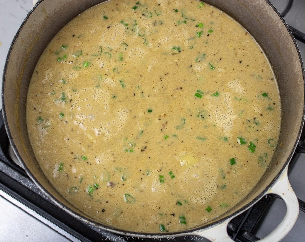 simmering oyster bisque in a Dutch oven