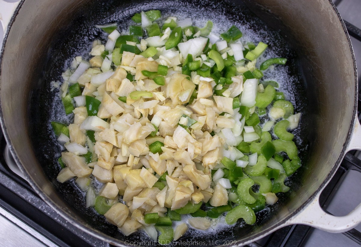 chopped vegetables sautéing in a Dutch oven