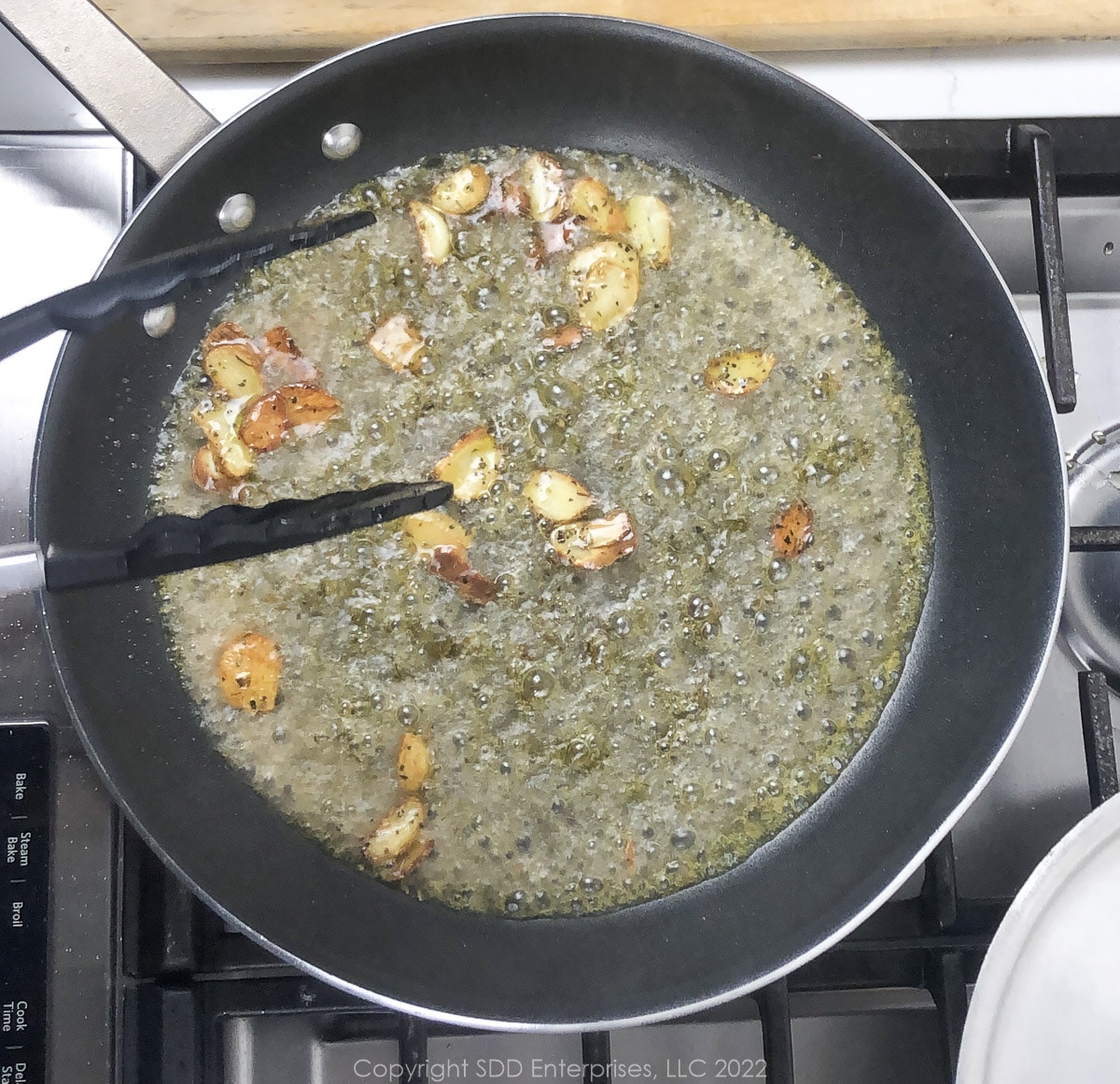 whine added to butter and garlic in a sauté pan